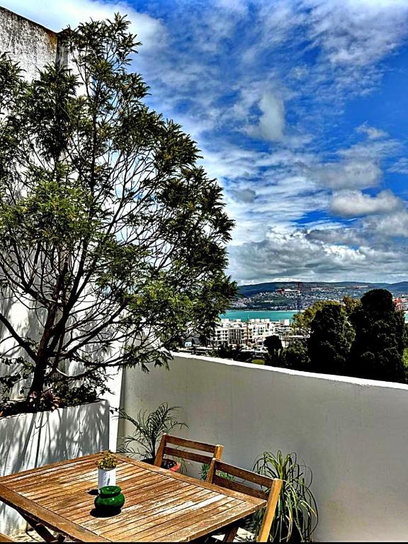 a wooden table and two chairs on a balcony at Dar el Marsa in Tangier