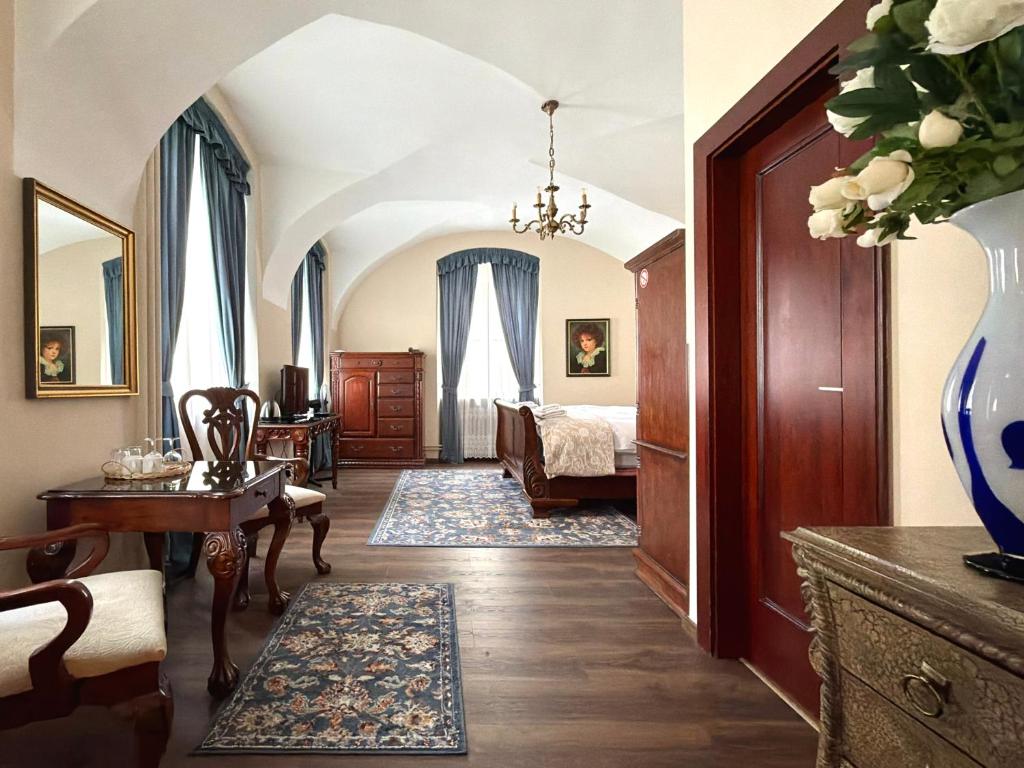 a room with a bedroom with a bed and a table at Prague Golden Age in Prague