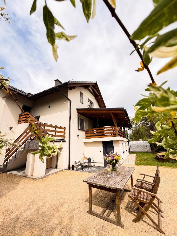 a house with a table and two chairs in front of it at Apartamenty Pawełek in Zator