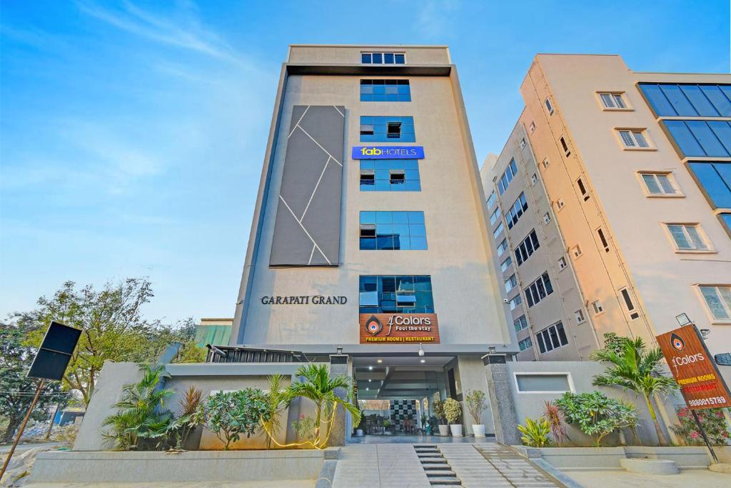 a tall building with a sign in front of it at FabHotel GG Stays in Lingampalli