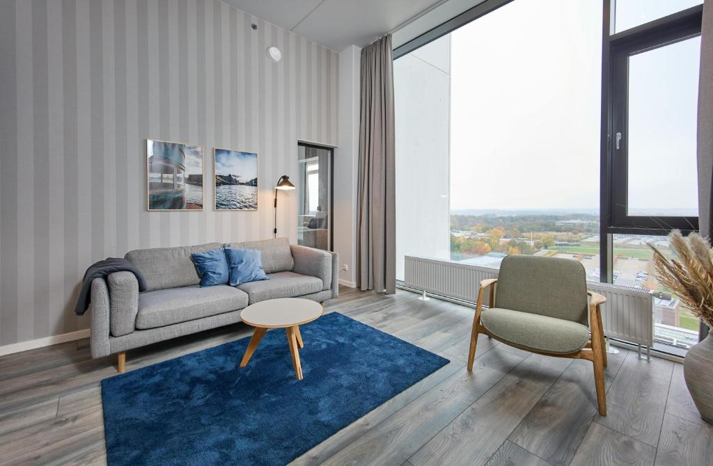 a living room with a couch and a chair at World Trade Center Ballerup - Forenom in Ballerup