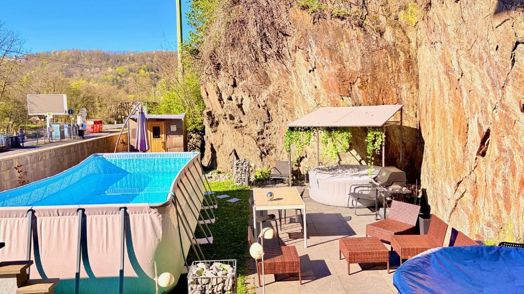 a swimming pool with a tent and a table and chairs at Whirlpool Sauna Pool Bad Ems in Bad Ems