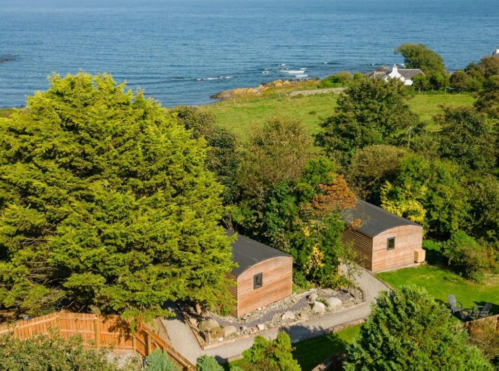 an aerial view of a house and the ocean at Ivy in Whithorn