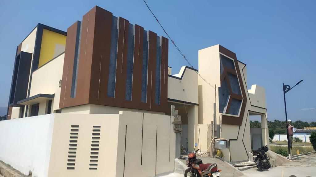 a building with two motorcycles parked in front of it at Solace in Coimbatore
