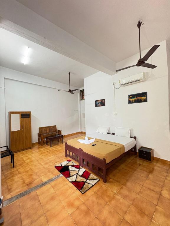 a room with a bed and a table in it at Elowen Suites in Manjeri