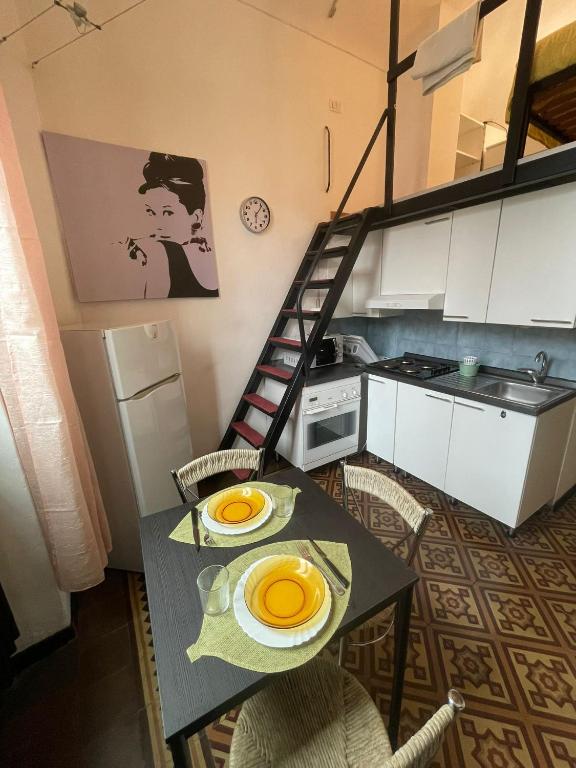 a small kitchen with a table with plates on it at Mivida Casa vacanze in Turin