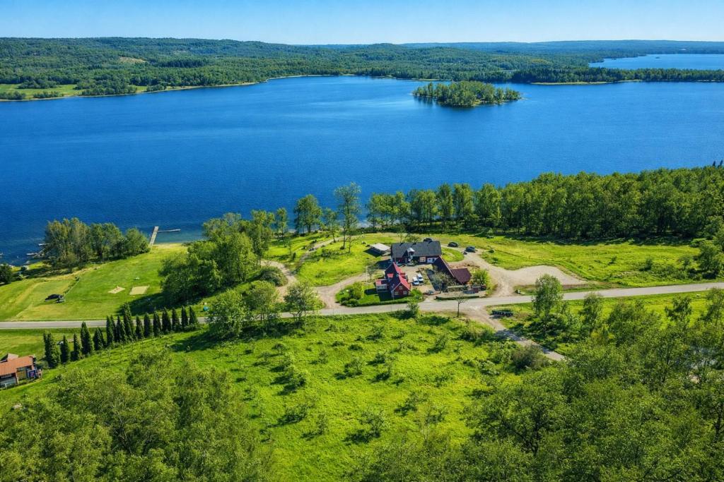 an aerial view of a house on a hill next to a lake at Vånga 771 in Örkelsö