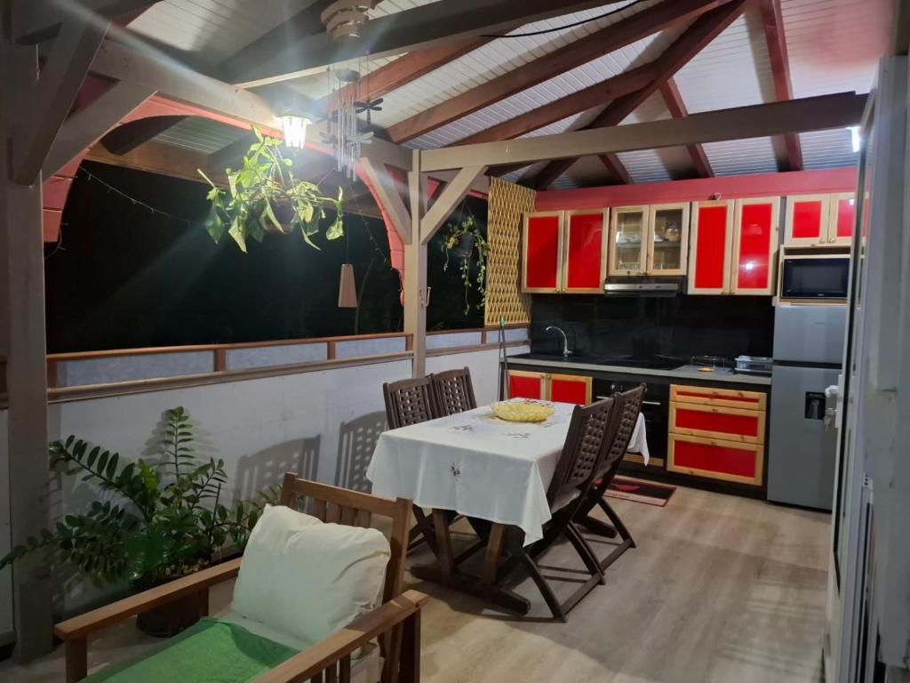 a kitchen with a table and chairs in a room at Kay Lydie in Saint-Joseph
