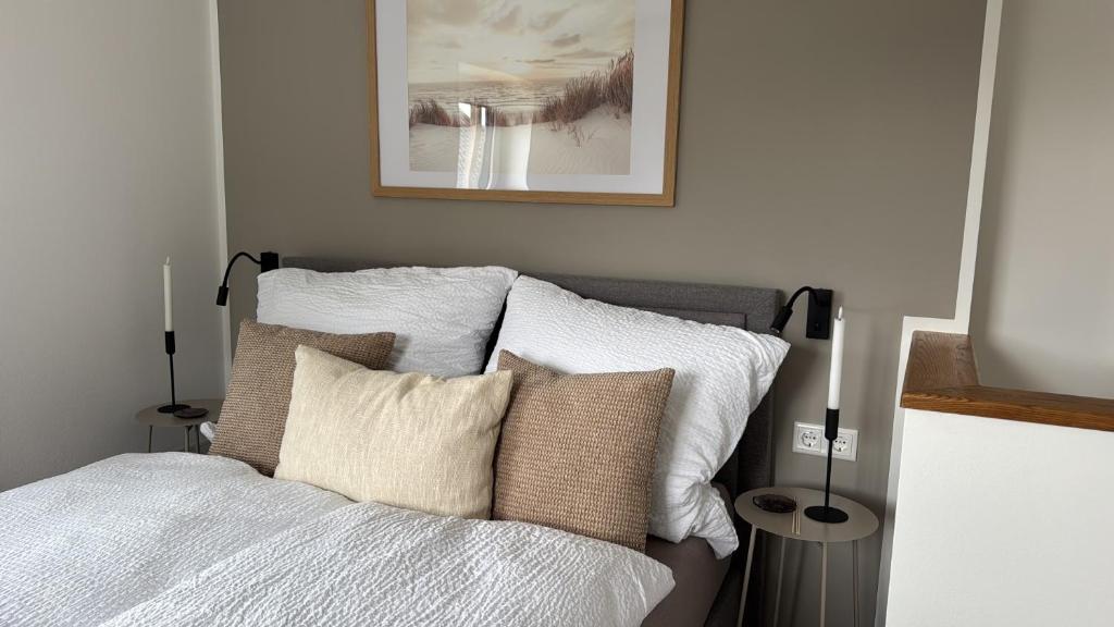 a bedroom with a bed with white sheets and pillows at Fichtennest in Sundern
