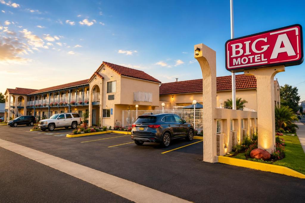 a large building with a big motel sign in a parking lot at Big A Motel & Suites Near Disneyland Orange County in Orange
