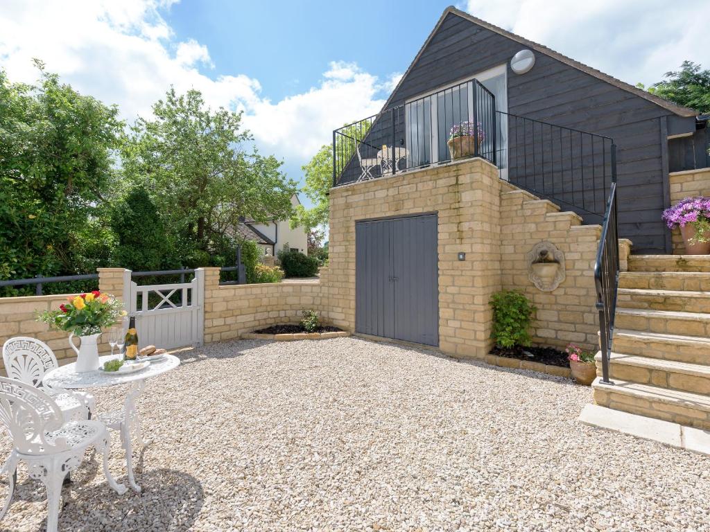 a patio with a building with a garage at The Apple Loft in Mickleton