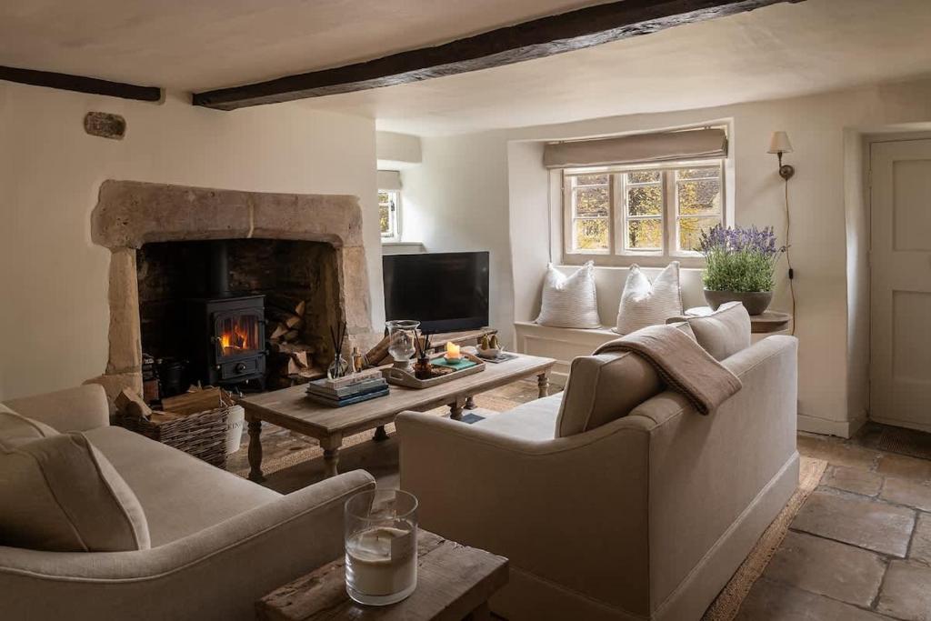 a living room with two couches and a fireplace at Hill View in Burford