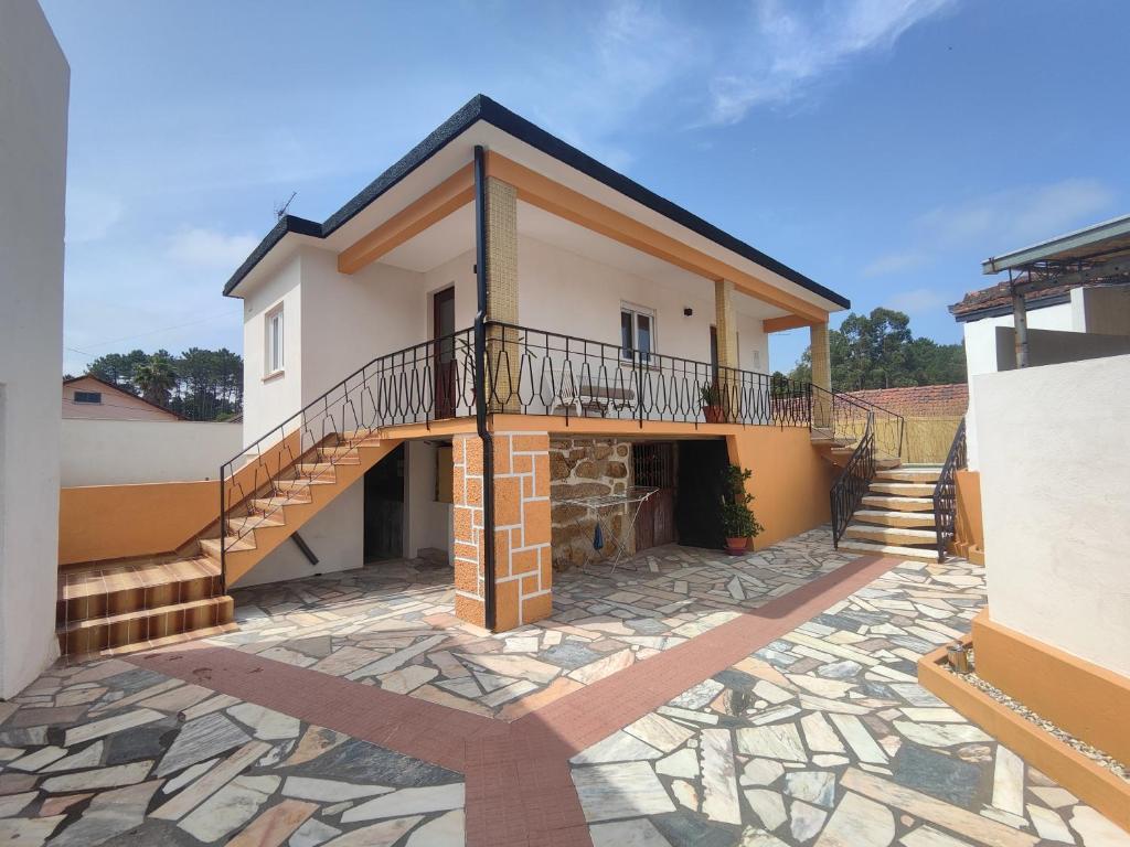 a house with a balcony on a stone patio at Marca 34 in Monção