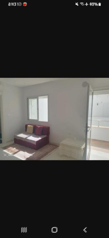 a picture of a bedroom with a bed and a window at Flat vacancy in Sousse