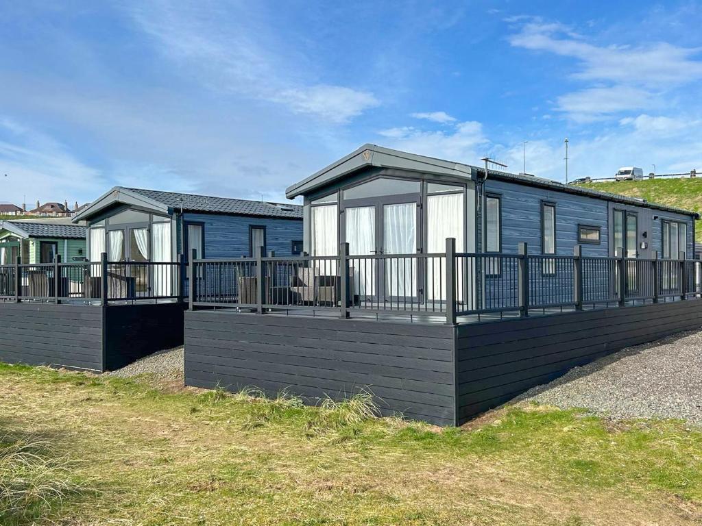a blue and white house with a balcony at Marina Escape One in Peterhead