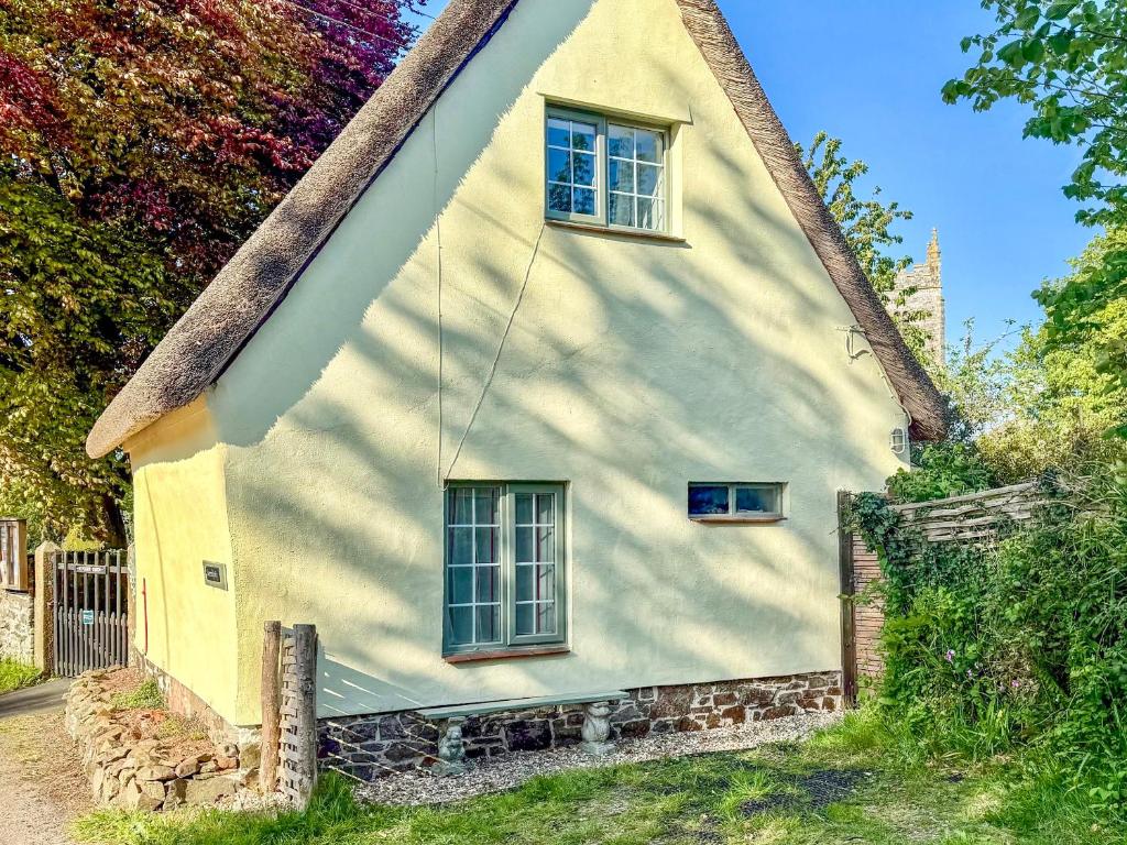 a white house with two windows and a fence at Serendipity in Molland