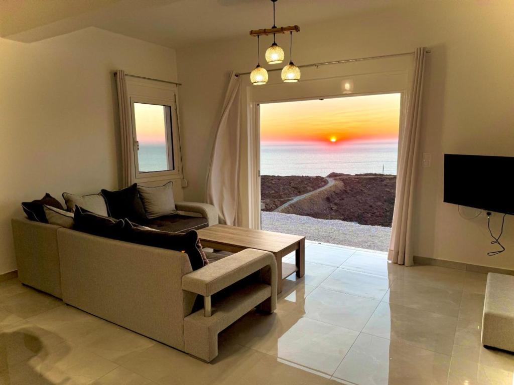 a living room with a couch and a table at Eagle's Nest Kythnos in Flampouria