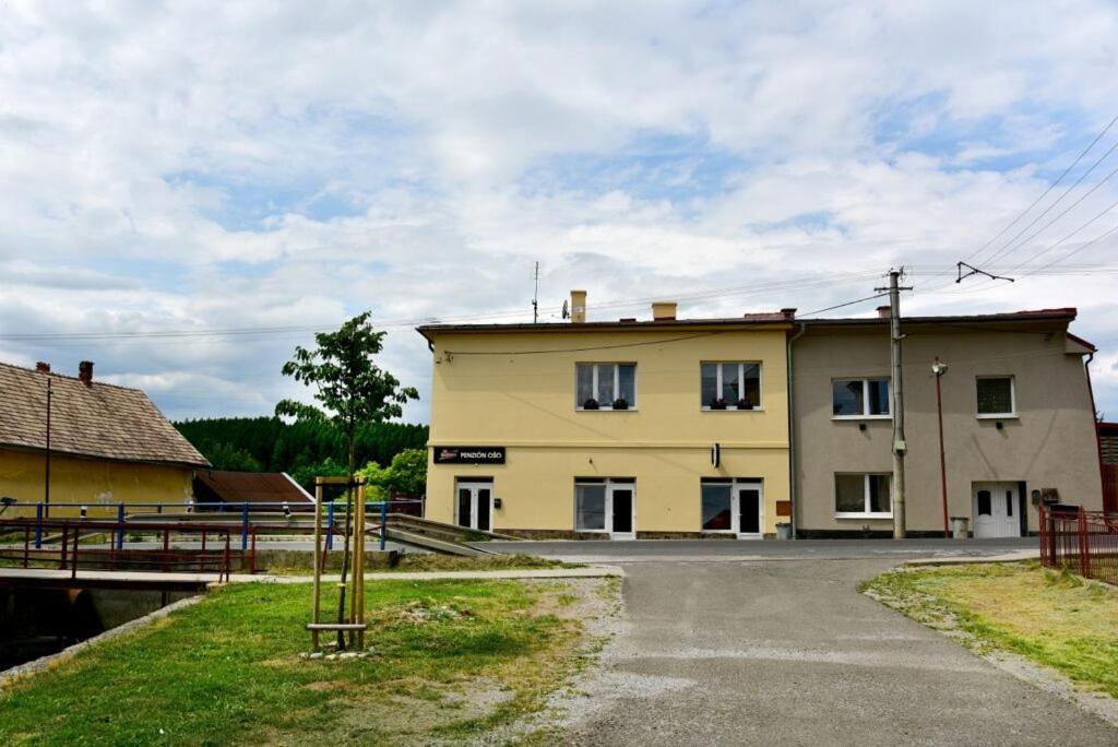 a large yellow building on the side of a road at Apartmány BRETZ in Vrbov