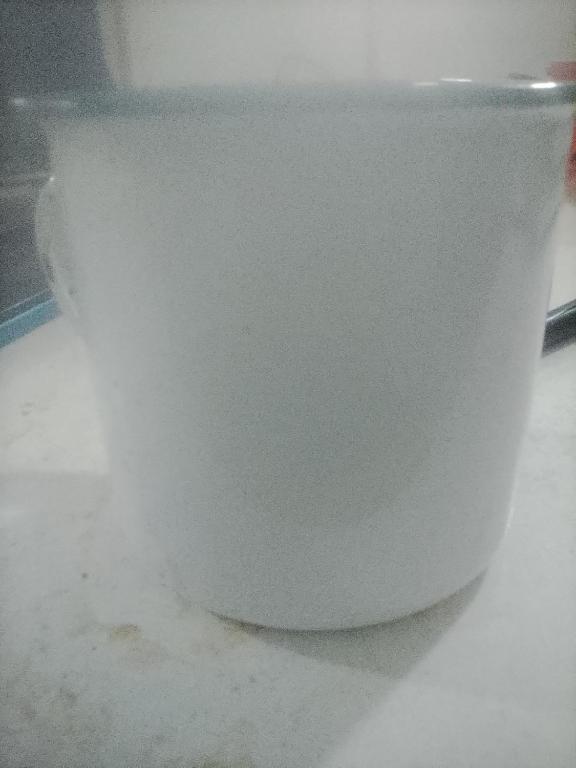 a white bucket sitting on top of a floor at Malome Lodge in Burgersfort