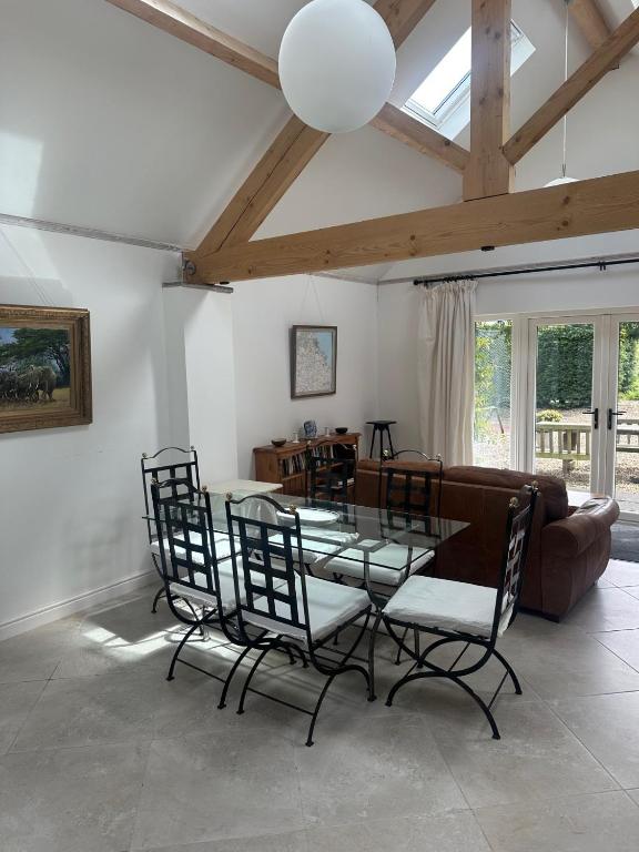 a living room with a table and chairs and a couch at The Studio in Willerby
