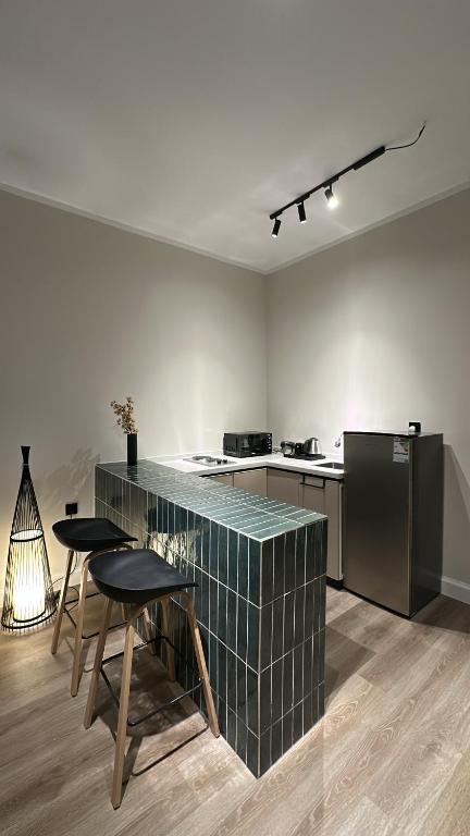 a kitchen with a counter and some tables and chairs at شقق مخدومة in Jazan