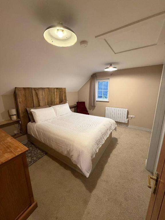 a bedroom with a large bed and a window at The Hilltop Hideaway in Enniskillen
