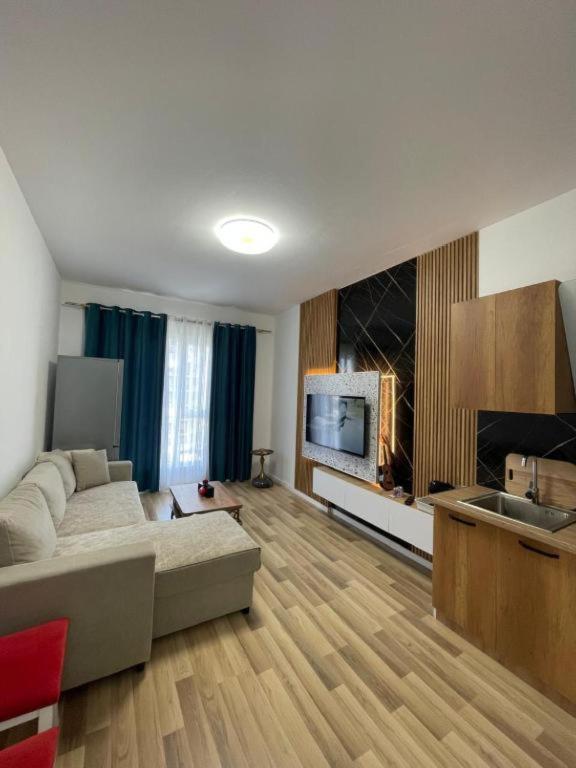 a large living room with a couch and a television at Enea Apartments 9 in Tirana
