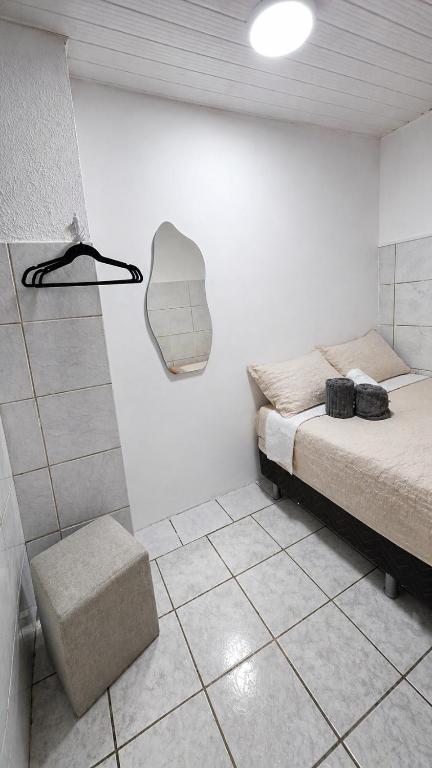 a white room with a bed and a shower at Q02 custo-benefício in São Luís