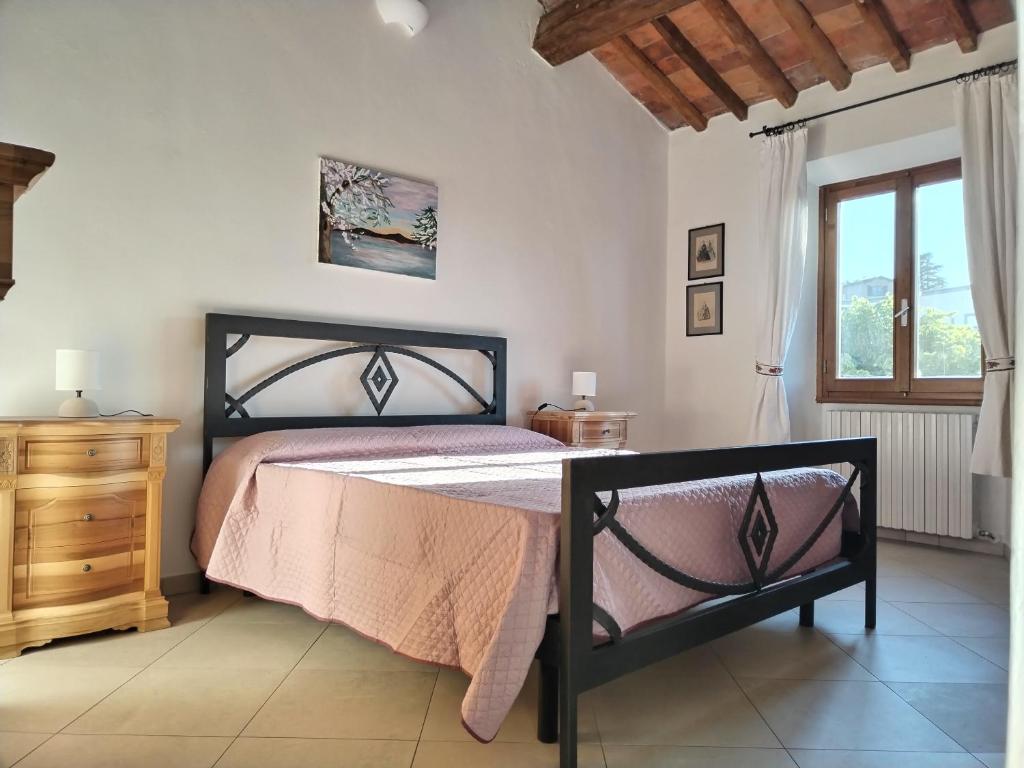 a bedroom with a bed and a dresser and a window at Martini River House in Barberino di Mugello