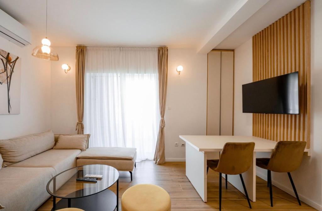 a living room with a couch and a table at Aurea Tivat Apartment in Tivat