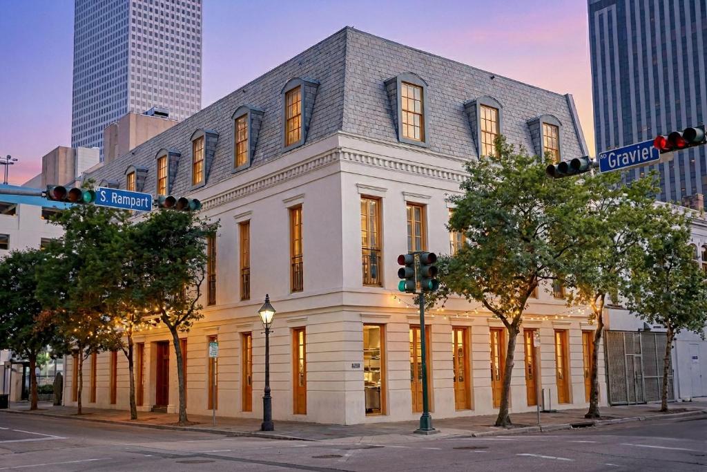 a white building on the corner of a street at The Louie Hotel New Orleans, Belvilla District 6 Formerly Sonder in New Orleans