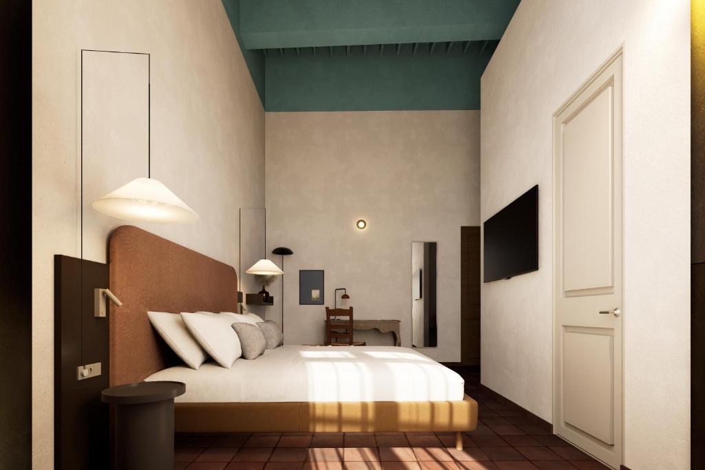 a bedroom with a bed with white sheets and a television at BYPILLOW Del Presto in Florence