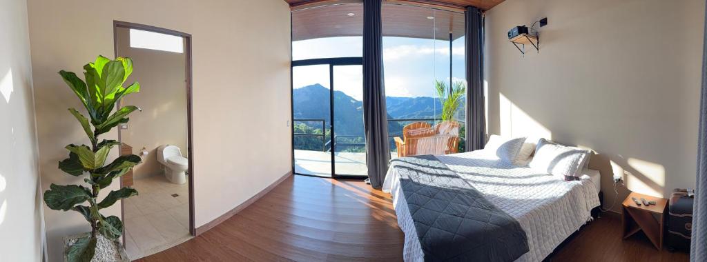 a bedroom with a bed and a large window at Payara Experience in La Vega