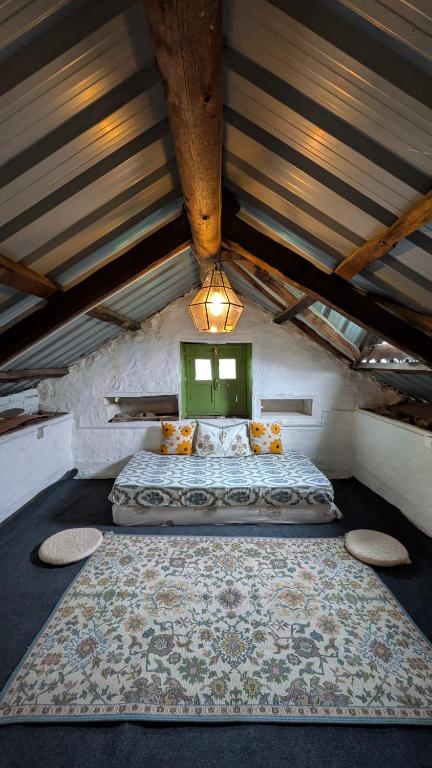 a bedroom with a large bed in a attic at Finding Clover in Banjār