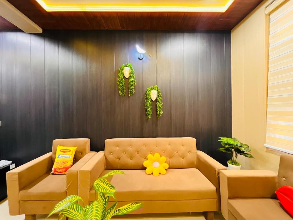 a living room with a couch with a flower on it at Ophelia in Agra