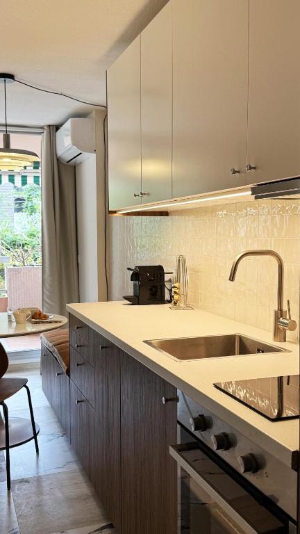 a kitchen with a sink and a counter top at Cozy Studio, Pool & Beaches 2 min away in Roquebrune-Cap-Martin