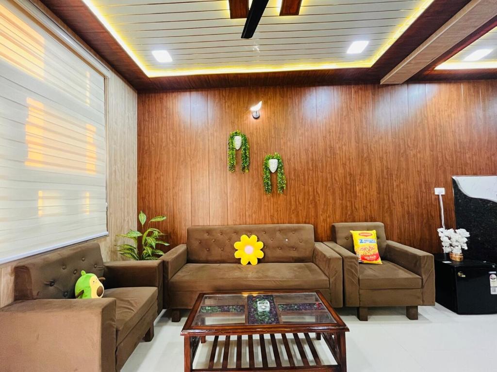 a living room with a couch and a table at Hogwood in Agra