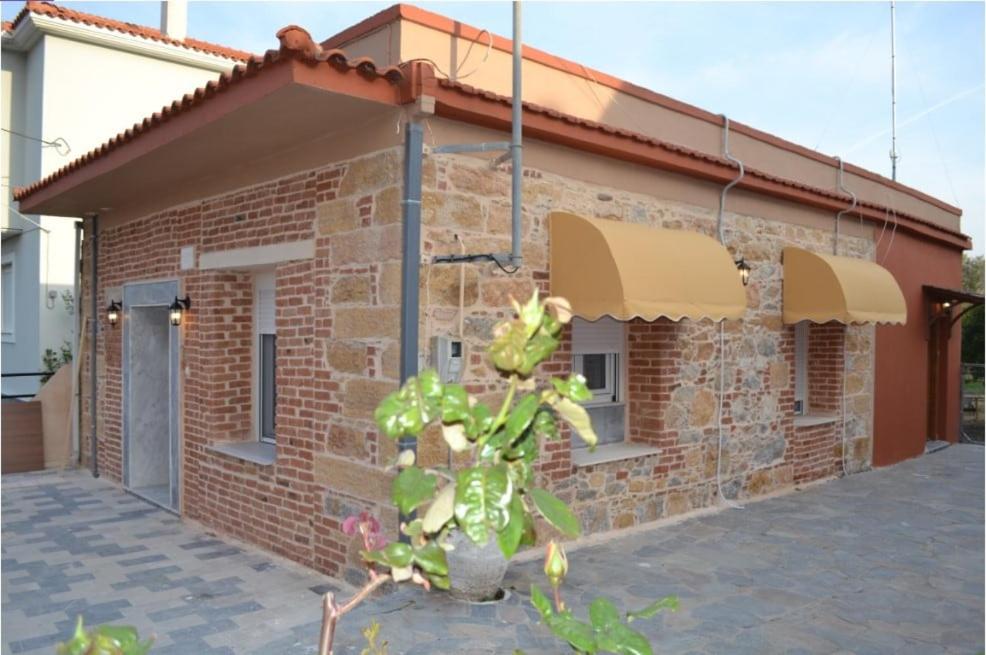 a brick house with a plant in front of it at Stone-built house Vrontados Chios 3' from beach in Vrontádos