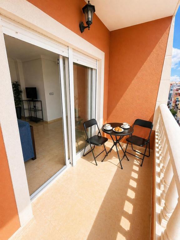 a balcony with a table and chairs on a balcony at La Riviera Residence in Rojales