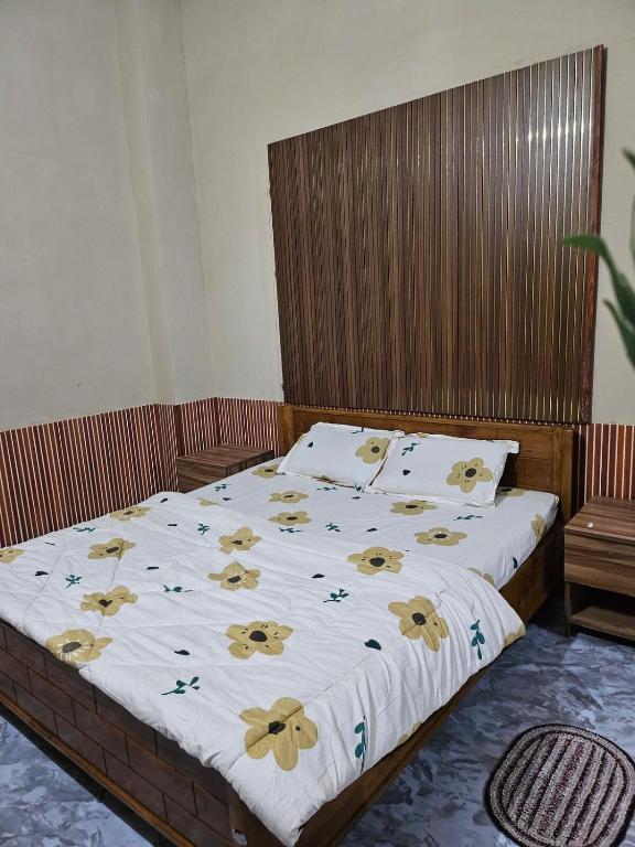 a bedroom with a bed with yellow butterflies on it at The Glory Apartment room 1 in Imphal