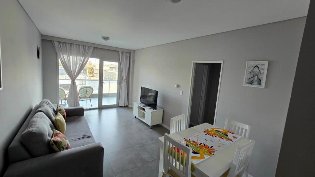 a living room with a couch and a table at Pardelas playa y ballenas in Puerto Madryn