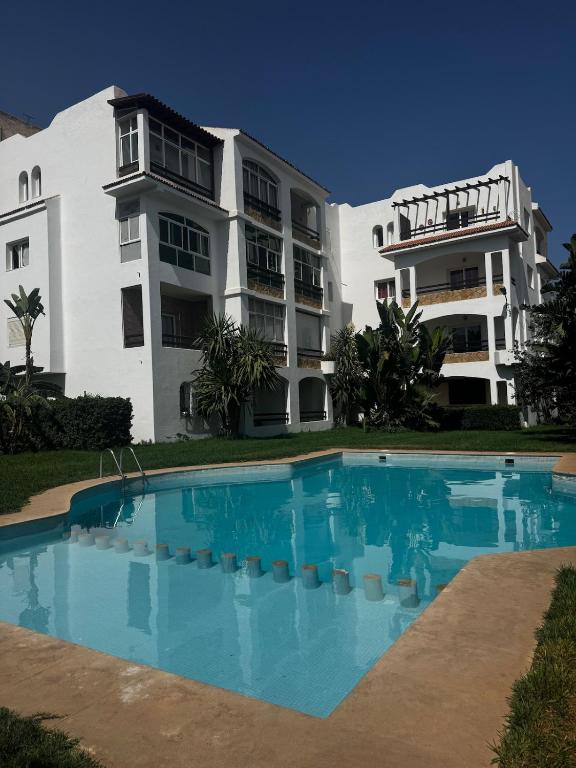 a building and a swimming pool in front of a building at Peaceful Haven with Pool, Breathtaking View in Oued Laou