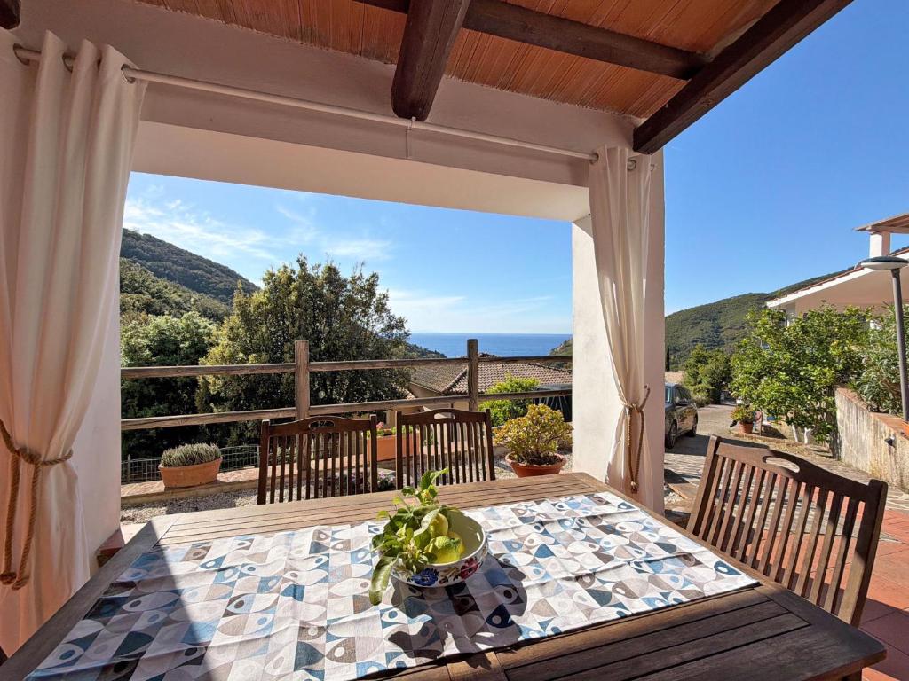 a table and chairs on a patio with a view at Casa Egy - ArgonautiVacanze in Casale Gastagno