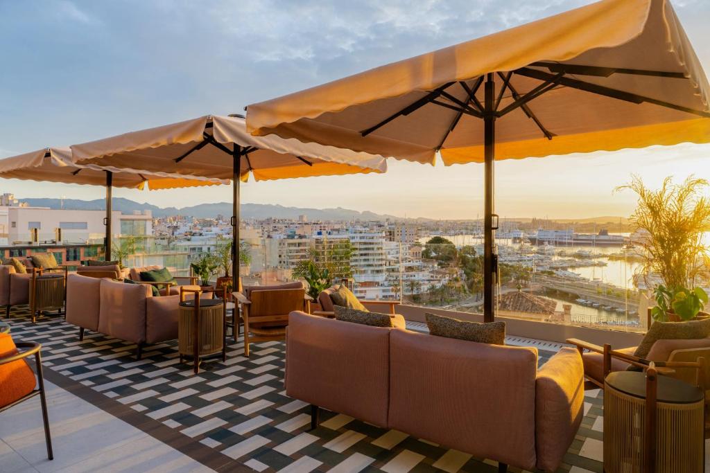 a restaurant with chairs and umbrellas on a roof at Catalonia Majórica in Palma de Mallorca