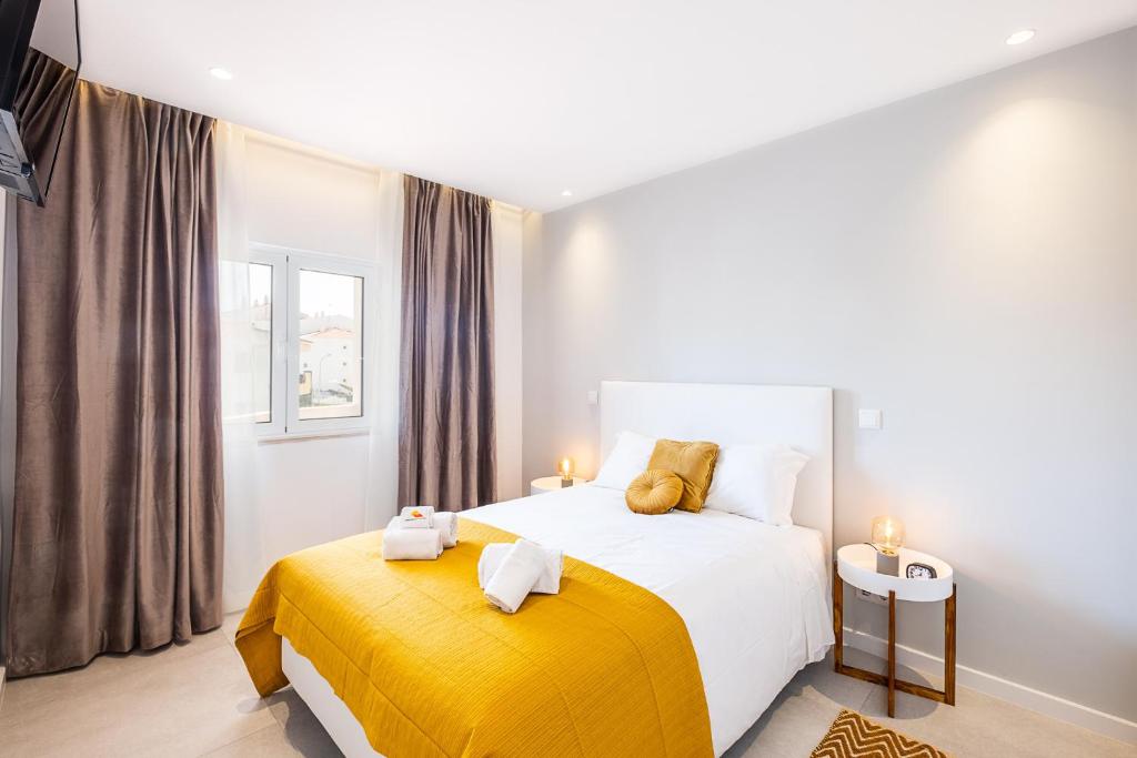 a bedroom with a bed with a yellow blanket at #081 1BR Vale Mangude Pool & Location in Albufeira