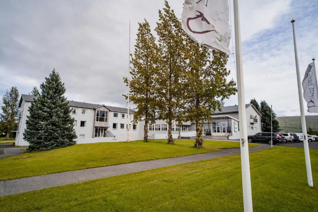 a flag in front of a white building at Hótel Valaskjálf in Egilsstaðir