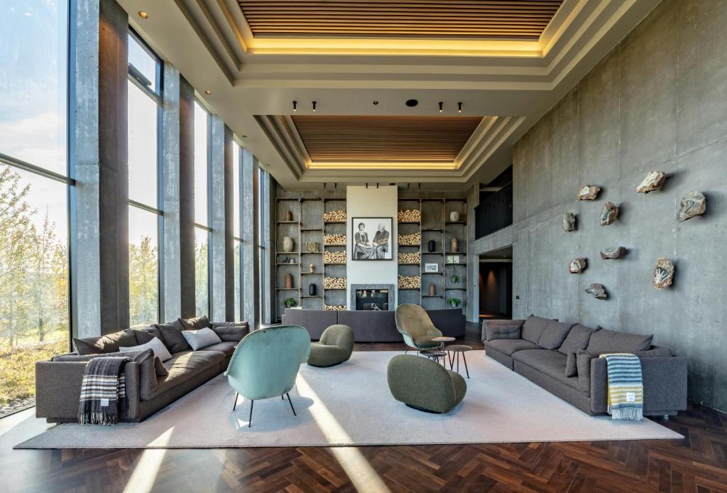 a living room with couches and chairs at Hotel Geysir in Geysir