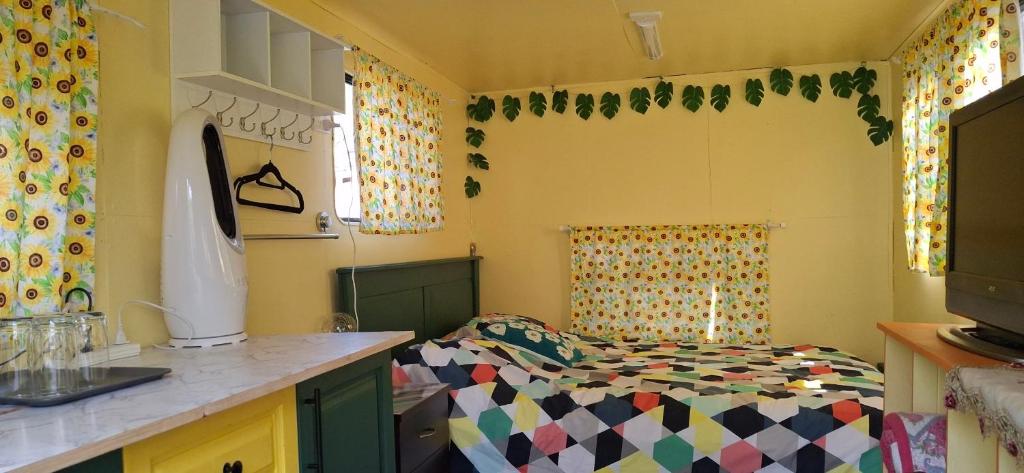 a kitchen with a bed in a room at Truck Caravan Rustic Sunflower in Mount Crosby