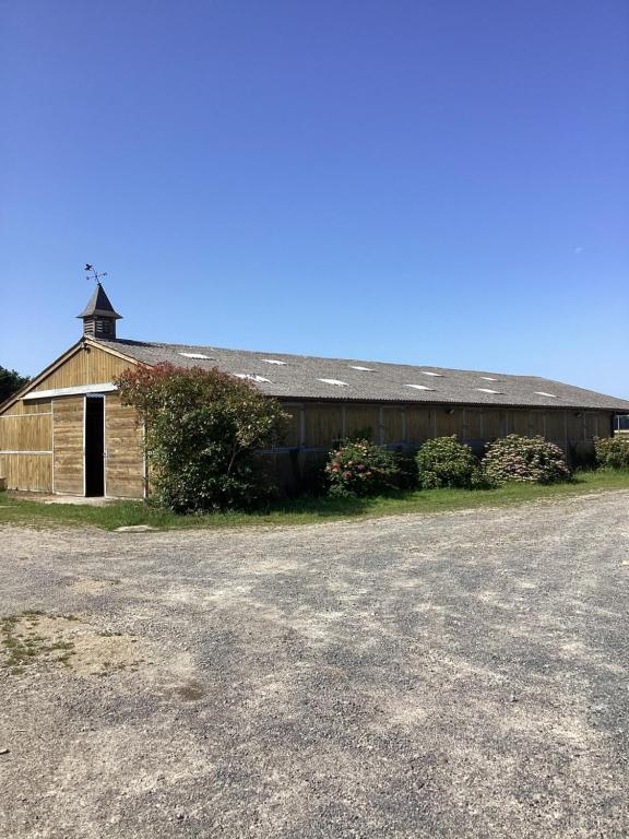 an old barn with a tower on top of it at Sci Licorne d Or in Saint-Méloir-des-Ondes