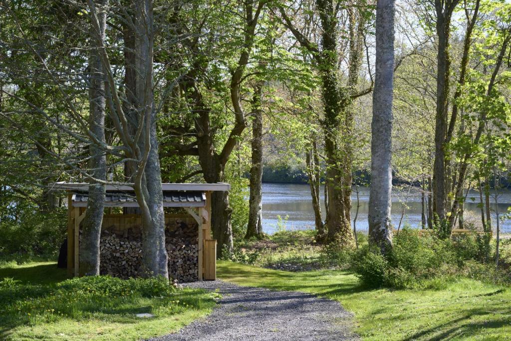 a wooden bench next to a path in a park at Church Cottage in Inverness